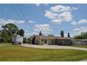 Spacious single-story home with a large front yard and extended driveway at 119 18Th Nw St, Ruskin, FL 33570