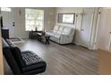 Cozy living room with light colored walls, luxury vinyl flooring, and lots of natural light at 12328 Shafton Rd, Spring Hill, FL 34608