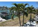 Backyard with palm trees with views of the water and boat docks at 12478 Capri Circle N # 2, Treasure Island, FL 33706