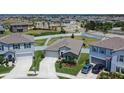 Aerial view of home showcasing its manicured lawn, driveway, and location within a well-maintained neighborhood at 13506 Wild Ginger St, Riverview, FL 33579