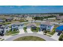 Wide aerial view of the property situated in a residential area with manicured lawns and community landscaping at 13506 Wild Ginger St, Riverview, FL 33579