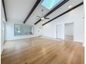 Open living area featuring hardwood floors, vaulted ceilings with beams, and lots of natural light at 13891 Feather Sound Dr, Clearwater, FL 33762