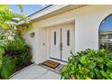 Inviting front entrance features double doors, a welcome mat, and manicured shrubbery at 14078 Leeward Dr, Seminole, FL 33776