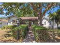 Charming home with a manicured yard and large tree providing ample shade at 1610 15Th N St, St Petersburg, FL 33704
