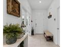 Welcoming entryway with neutral tile flooring, white walls and decorative accents at 16633 Goose Ribbon Pl, Wimauma, FL 33598