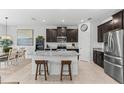 Kitchen with granite countertops, stainless steel appliances, and seating at the island at 16633 Goose Ribbon Pl, Wimauma, FL 33598