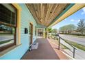 Spacious front porch with a wooden ceiling, offering a relaxing outdoor space at 1708 E 15Th Ave, Tampa, FL 33605