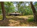 Large outdoor barn surrounded by trees and grass at 19266 Campground Rd, Brooksville, FL 34601