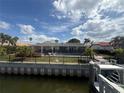 Waterfront backyard featuring a private pool, fenced yard, and boat dock for endless outdoor fun at 1929 Iowa Ne Ave, St Petersburg, FL 33703