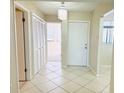 Bright foyer featuring modern chandelier, diamond-pattern tile flooring, and closet space at 2024 Blue Hawk Ct # 1822, Clearwater, FL 33762