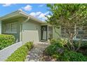 Inviting front entrance with a walkway leading to the front door, framed by lush landscaping at 2060 Attache Ct, Clearwater, FL 33764