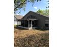 View of the screened in porch with access door and neutral exterior at 3314 Pine Top Dr, Valrico, FL 33594