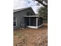 View of the screened in porch with white trim and neutral exterior at 3314 Pine Top Dr, Valrico, FL 33594