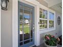 Stylish front door with glass panels, complemented by decorative plants, creating a warm entry at 3906 W De Leon St, Tampa, FL 33609