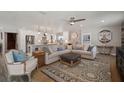 Open-concept living room flows into the kitchen, featuring a large sectional sofa and stylish decor at 3906 W De Leon St, Tampa, FL 33609
