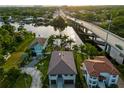 Aerial view of waterfront homes, the waterway, bridge and lush landscaping on a sunny day at 3924 N Ridge Ave, Tampa, FL 33603