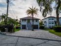 Charming two-story home with a well-maintained brick driveway and a beautiful palm tree in the front yard at 3924 N Ridge Ave, Tampa, FL 33603