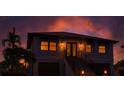 Striking image of a two-story home at dusk with illuminated windows and stairwell lighting at 3924 N Ridge Ave, Tampa, FL 33603