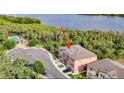 An aerial view shows a townhome near a beautiful lake surrounded by trees and other condos at 4624 Willet Cooper Ct, Tampa, FL 33619