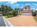 Beautiful suburban home with a red tile roof, manicured landscaping, and a spacious brick driveway at 4815 Queen Palm Ne Ter, St Petersburg, FL 33703