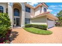 Charming home with a brick driveway, well-maintained lawn, and an attached two-car garage at 4815 Queen Palm Ne Ter, St Petersburg, FL 33703