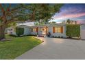 A charming home with wood-look shutters set against a beautiful sunset backdrop at 4920 17Th N Ave, St Petersburg, FL 33710