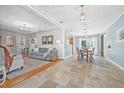 Open-concept living and dining area with neutral tones, tile floors, and abundant natural light at 4920 17Th N Ave, St Petersburg, FL 33710