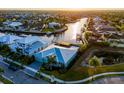 Gorgeous waterfront home with lush tropical landscaping, a metal roof, and stunning water views at 5603 Tybee Island Dr, Apollo Beach, FL 33572