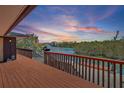 Waterfront home with a wooden deck and views of the canal and lush mangroves at 588 Bayview Dr, Longboat Key, FL 34228