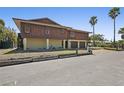 Two-story home with brown wood paneling, two-car garage, and well-maintained lawn at 588 Bayview Dr, Longboat Key, FL 34228