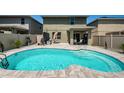 In-ground pool and patio with shaded outdoor seating area, and privacy fence at 5928 81St N Ave, Pinellas Park, FL 33781