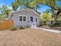 Attractive single-story home with a blue front door and manicured front yard at 8114 N 11Th St, Tampa, FL 33604