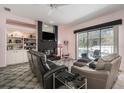 Inviting living room with a black brick fireplace, built-in shelving, and access to the pool at 8406 Glengarry Pl, Trinity, FL 34655