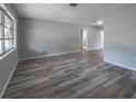 Spacious living room with wood-look flooring and neutral walls at 916 Gillespie St, Englewood, FL 34223