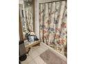Bathroom with a decorative shower curtain and gold-trimmed mirror at 9481 Patrick St, Brooksville, FL 34601