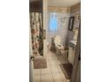 Full bathroom featuring toilet, shower with curtain, and vanity sink at 9481 Patrick St, Brooksville, FL 34601