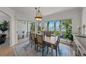 Bright dining room features a view of the water, an elegant light fixture, and stylish decor at 1117 Shipwatch Cir, Tampa, FL 33602