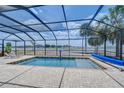 Relaxing screened-in pool area with pavers and lounge chairs offering serene outdoor living at 11427 Laurel Brook Ct, Riverview, FL 33569