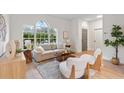 Bright living room with large windows, light neutral colors, and contemporary furniture at 12531 Blazing Star Dr, Tampa, FL 33626