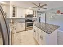 Modern kitchen features white cabinets, stainless steel appliances, and granite countertops at 13208 Sydney Rd, Dover, FL 33527