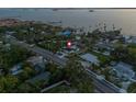 Gorgeous aerial shot of waterfront property with private pool in residential neighborhood near open water at 1542 Bayshore Blvd, Dunedin, FL 34698