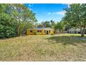 Well-maintained home with a lovely front lawn and mature trees at 1665 Laura St, Clearwater, FL 33755