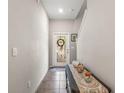 Bright foyer with neutral walls, tiled floor, decorative wreath on the glass front door, and stairway access at 16930 Red Brick Ln, Land O Lakes, FL 34638