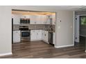 Beautifully updated kitchen featuring white cabinets, stainless steel appliances, granite countertops, and new wood flooring at 1914 53Rd S St, Gulfport, FL 33707