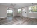 Bright, neutral living room showcasing new floors, fresh paint, and plenty of natural light from the multiple windows at 1914 53Rd S St, Gulfport, FL 33707