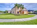 Charming two-story home featuring a three-car garage, lush lawn, and landscaping at 19533 Whispering Brook Dr, Tampa, FL 33647