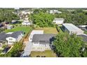 Aerial view of a house with a large backyard, complete with lush greenery and a detached shed at 2288 Cheryl Rd, Largo, FL 33771
