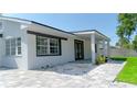 Charming home featuring small rocks, with gray brick driveway and a light gray exterior paint at 2288 Cheryl Rd, Largo, FL 33771