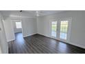 Bright living room featuring hardwood floors, a ceiling fan, and a sliding glass door providing lots of light at 2288 Cheryl Rd, Largo, FL 33771
