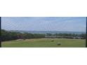 View of golf course from lanai with golf carts, trees and the Gulf at 2618 Cove Cay Dr # 403, Clearwater, FL 33760